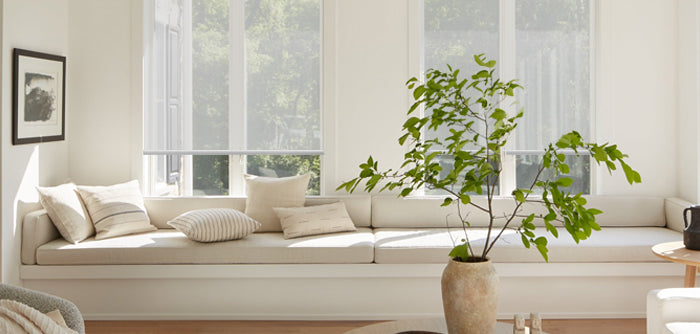 The living room has windows and relatively transparent shades