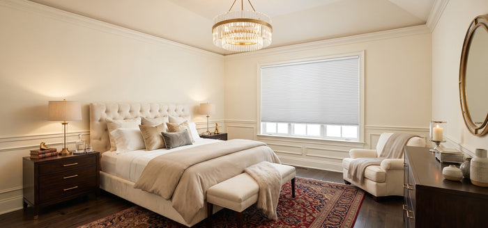 The bedroom windows are adorned with motorized cellular shades, creating a classic, elegant, bright, and harmonious atmosphere.