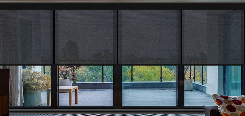 Roller shades on floor-to-ceiling windows