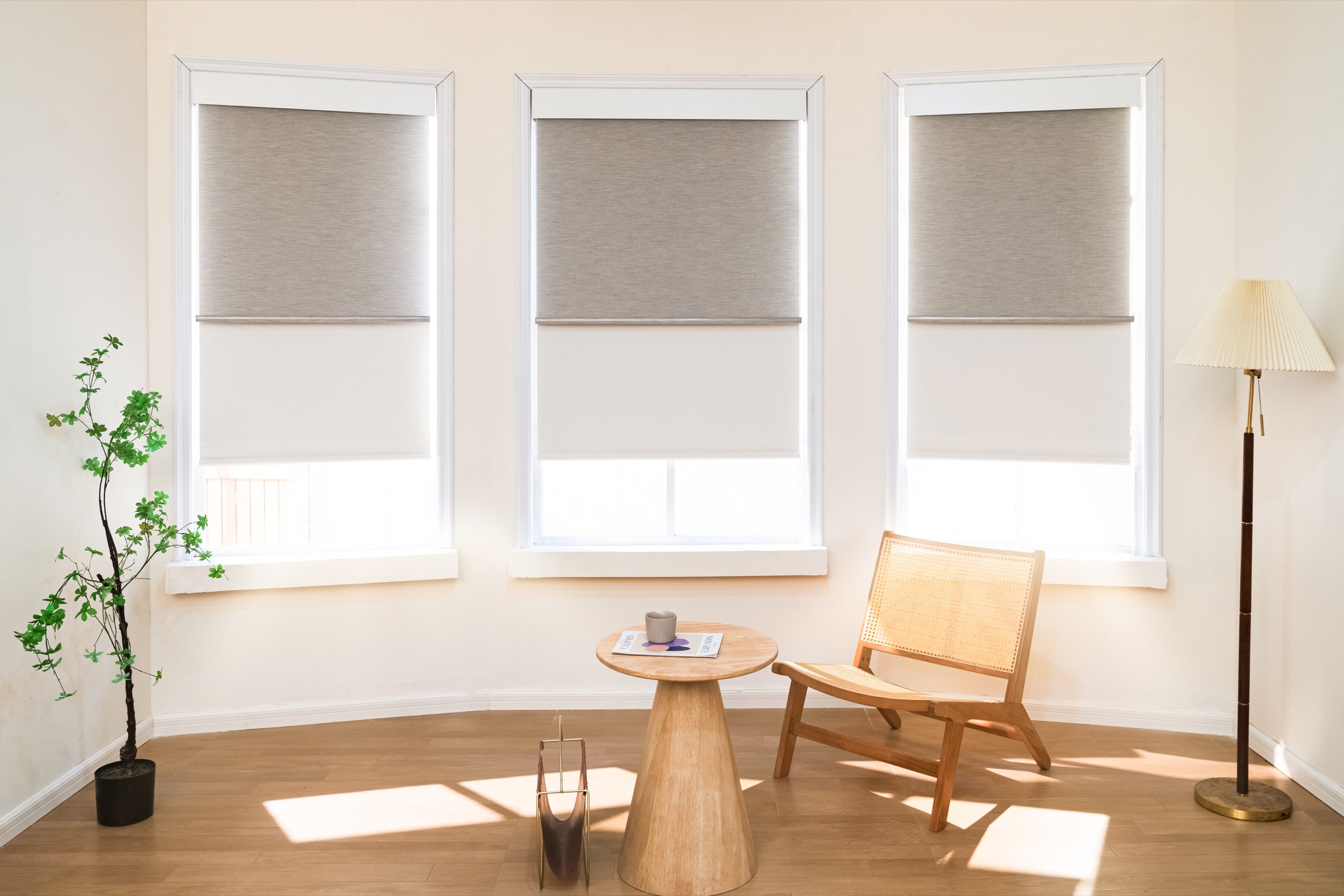 Three battery-powered roller shades in a bright finished living room