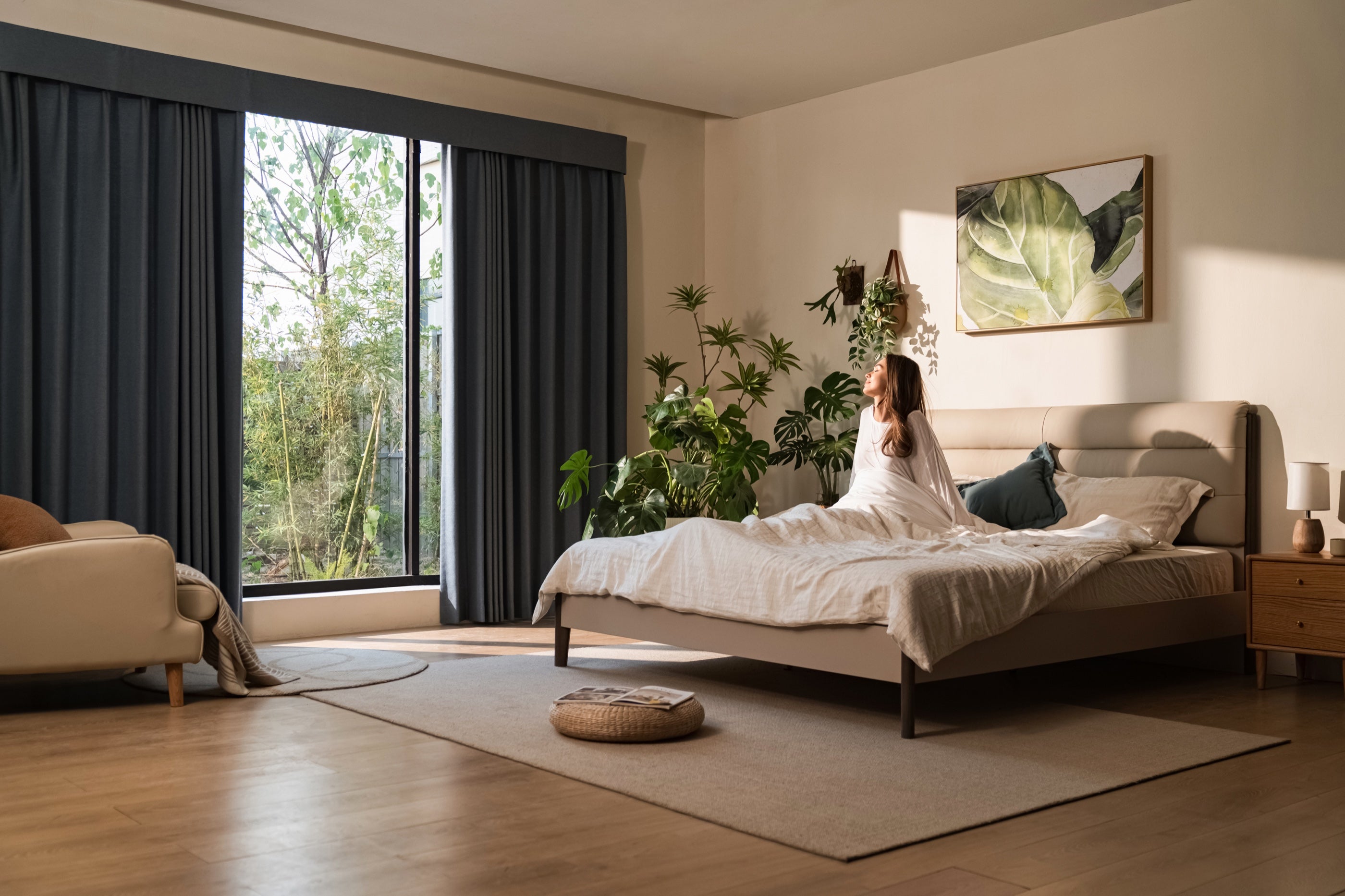 A bedroom with large hardwired motorized curtains
