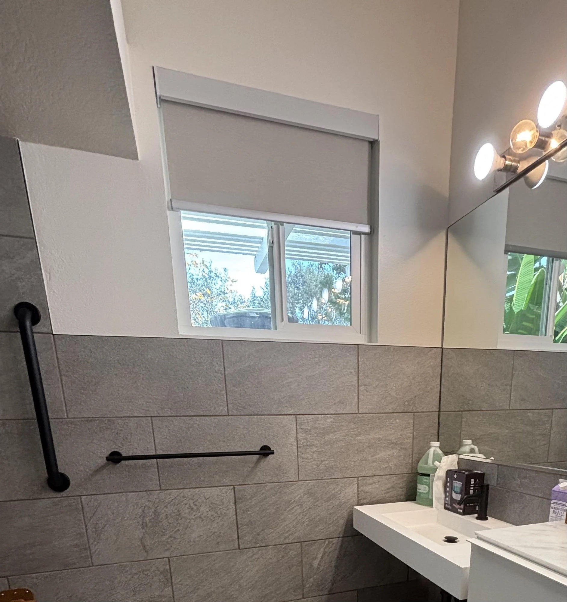 Roller shade installed in a bathroom