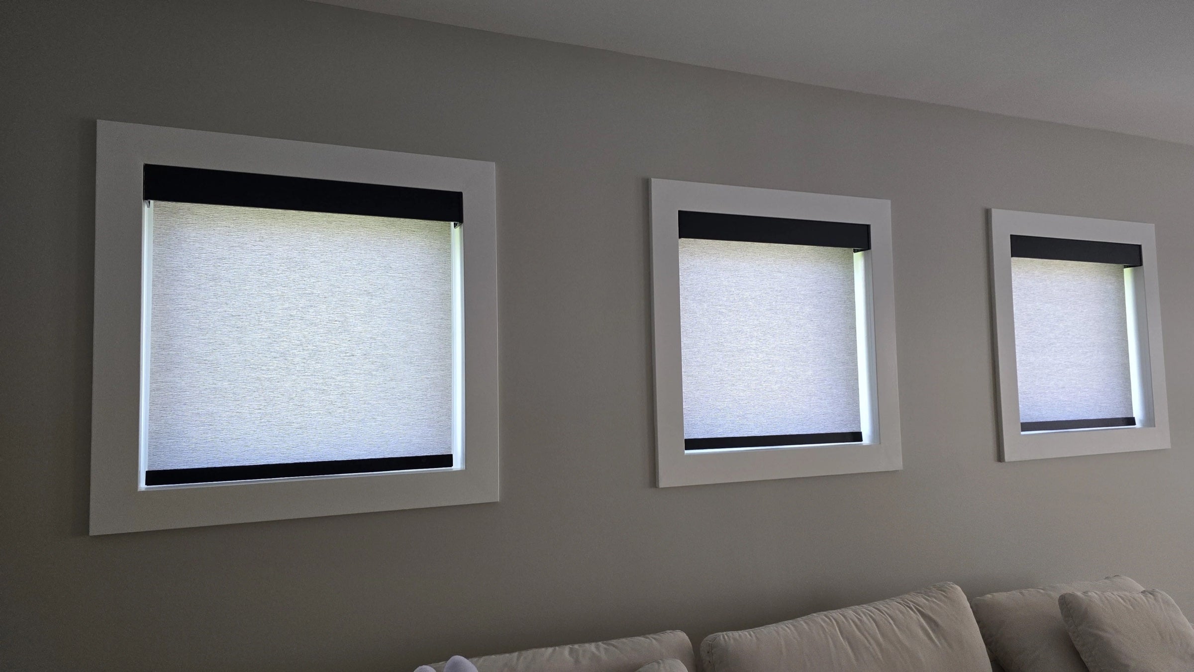 Three roller shades with black valances