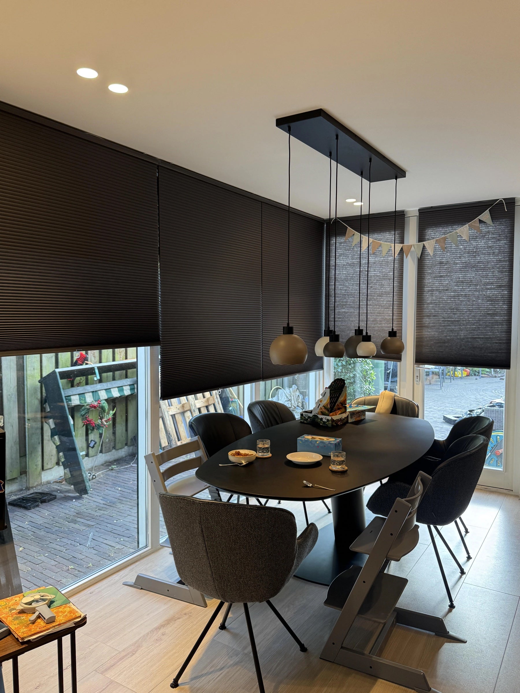 Dark cellular shades in a family dining room