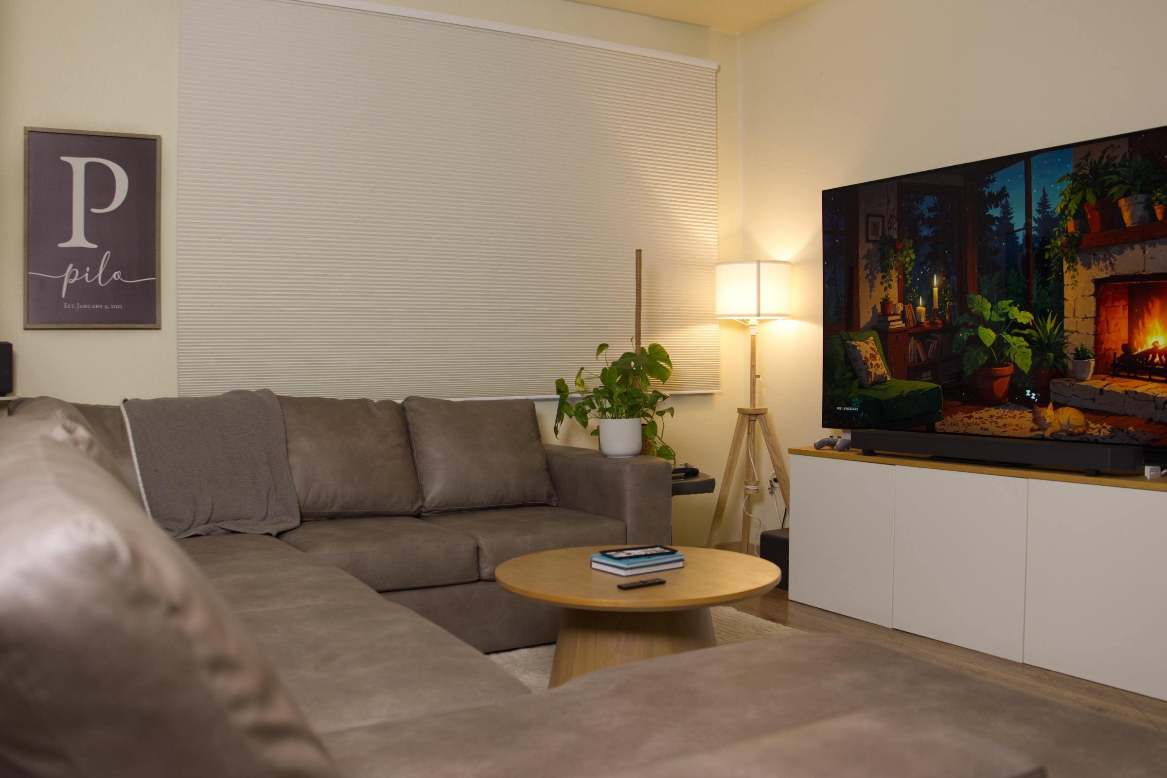 Warm living room with SmartWings cellular shades at night