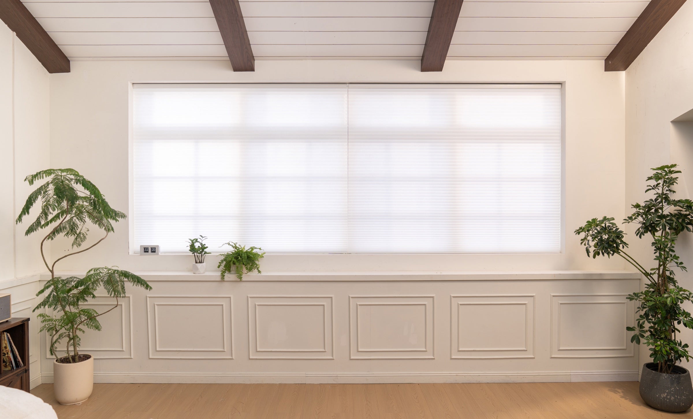 Bright SmartWings cellular shades in a warm plant-filled room